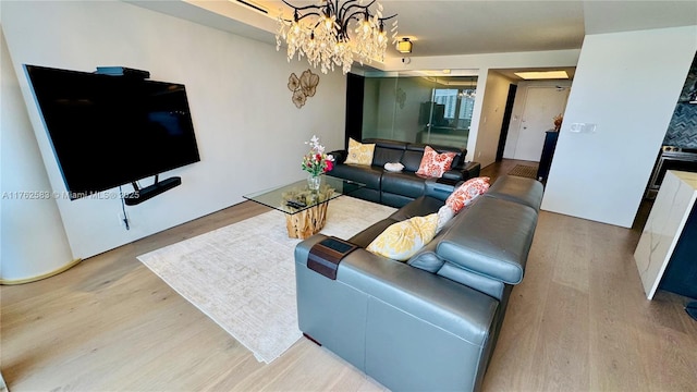 living room featuring a chandelier and wood finished floors