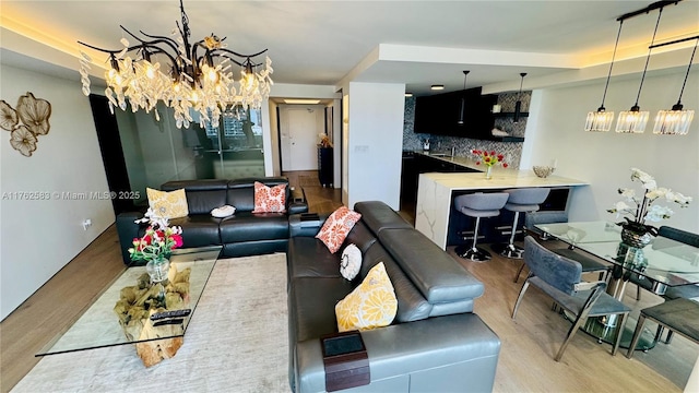 living room with an inviting chandelier and wood finished floors