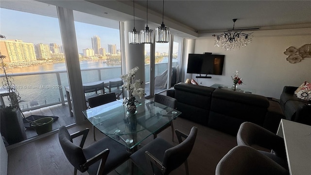 living area with an inviting chandelier and a water view