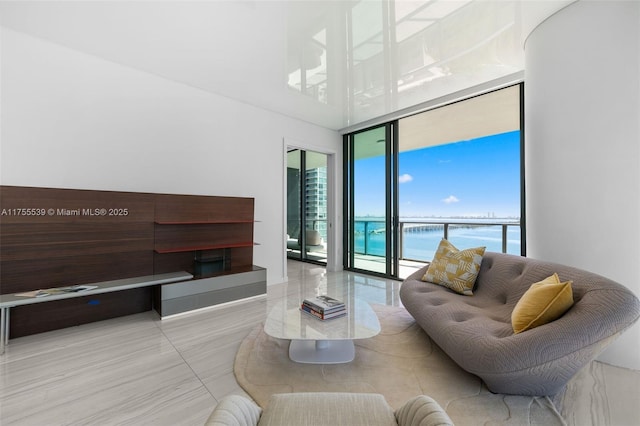 living area with a wall of windows and a water view