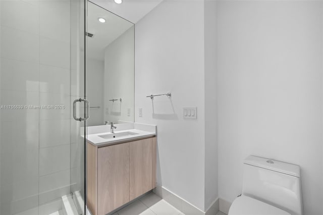 full bath with toilet, a stall shower, tile patterned flooring, baseboards, and vanity