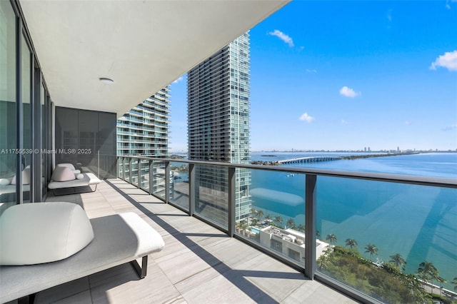 balcony featuring a water view and a view of city