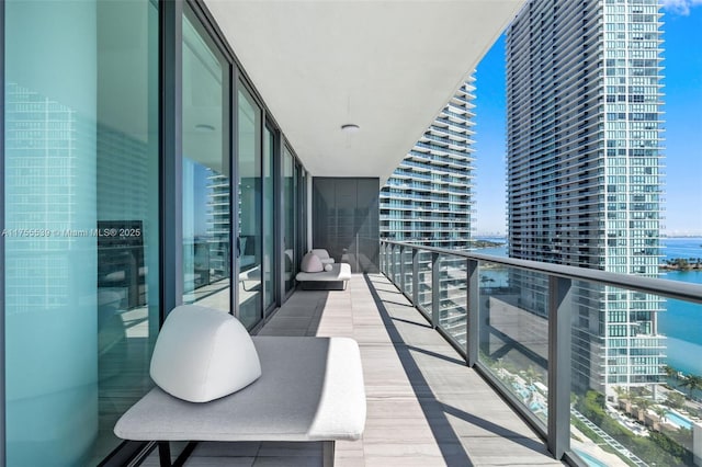 balcony featuring a water view and a view of city