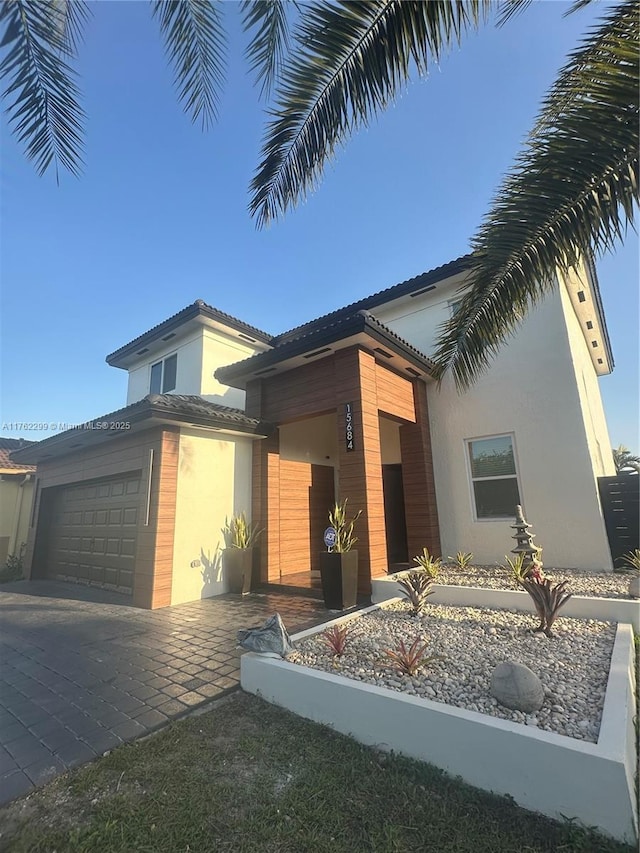 view of front of house with stucco siding and an attached garage