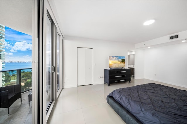 bedroom featuring baseboards, visible vents, light tile patterned flooring, recessed lighting, and a water view