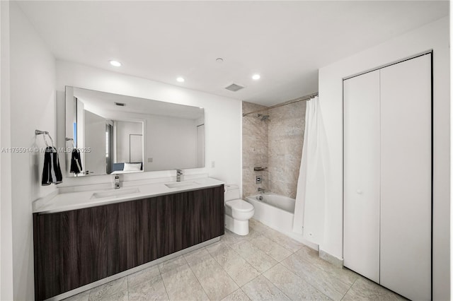 bathroom with a sink, toilet, shower / bath combo, and double vanity