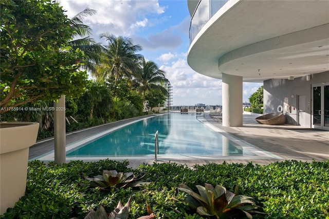 community pool with a patio area