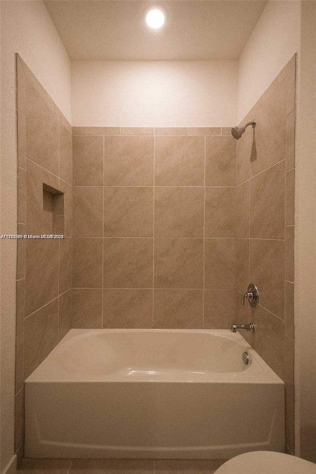 bathroom featuring toilet and  shower combination