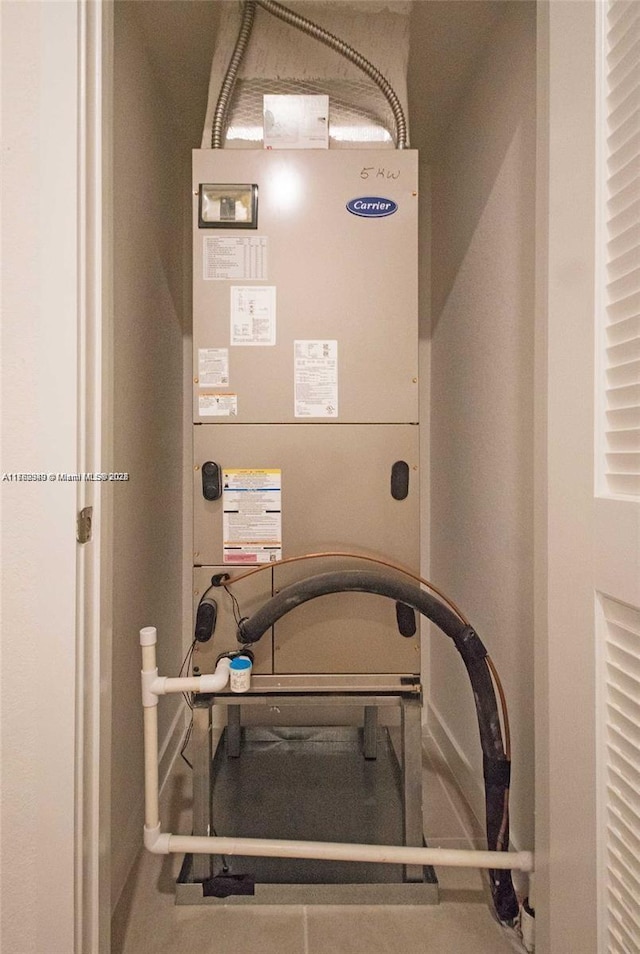 utility room featuring heating unit