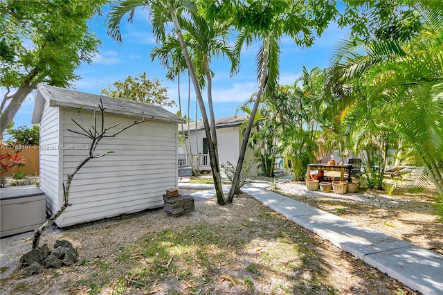 view of yard with an outbuilding and a shed