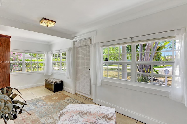 living area featuring light tile patterned floors and baseboards