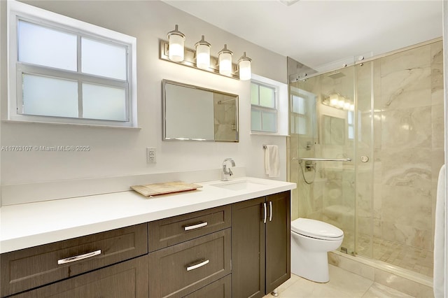 full bath with vanity, a shower stall, toilet, and tile patterned flooring