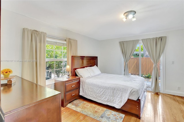 bedroom with light wood-style floors and baseboards