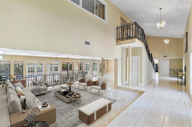 tiled living area featuring a wealth of natural light, visible vents, stairs, and an inviting chandelier