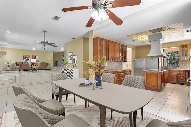 dining area with light tile patterned floors, a ceiling fan, and visible vents