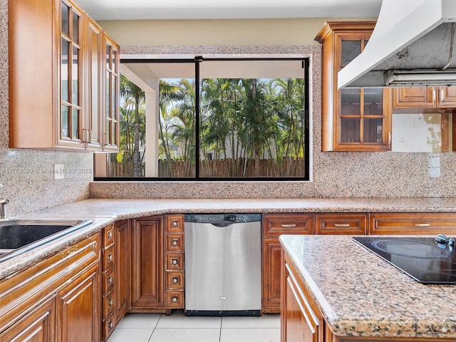 kitchen featuring ventilation hood, light tile patterned floors, brown cabinetry, dishwasher, and black electric cooktop