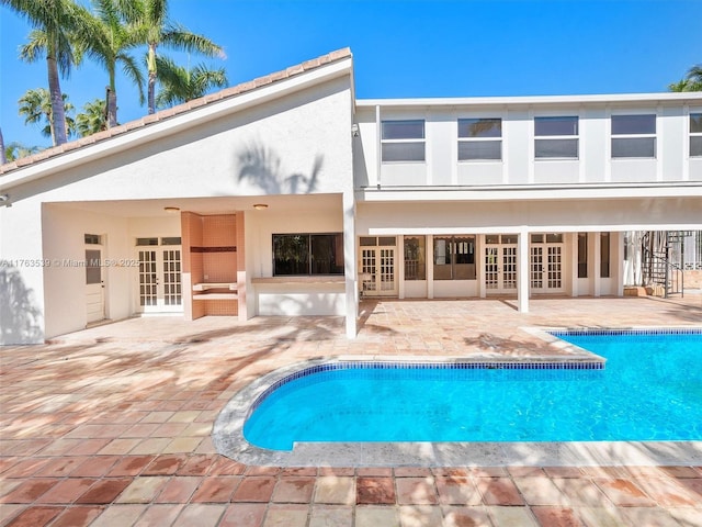 pool featuring a patio and french doors