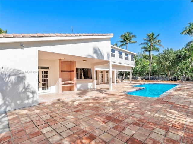 view of pool with a patio area, a fenced in pool, french doors, and fence