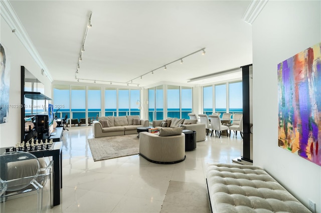 tiled living room with track lighting, floor to ceiling windows, a water view, and ornamental molding