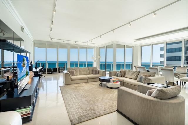 living area with track lighting, a water view, visible vents, and expansive windows