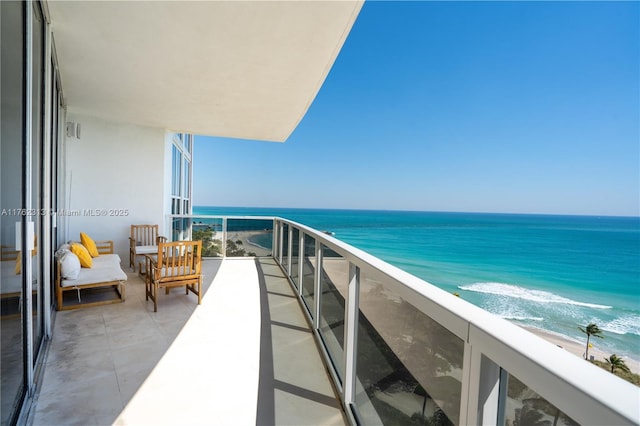 balcony with a beach view and a water view