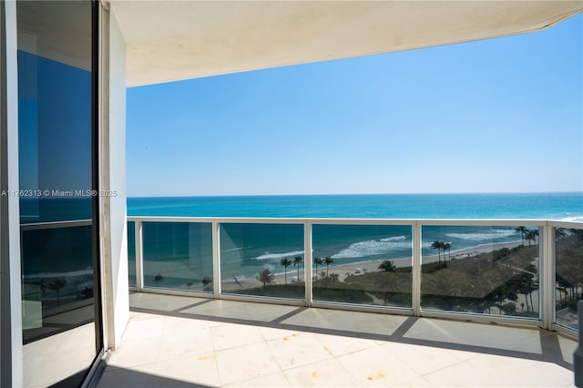 balcony with a beach view and a water view