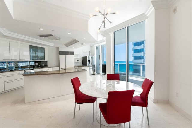 dining room featuring recessed lighting, baseboards, a notable chandelier, and crown molding