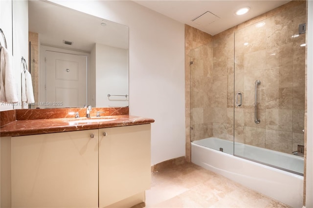 full bathroom featuring vanity, baseboards, visible vents, and enclosed tub / shower combo