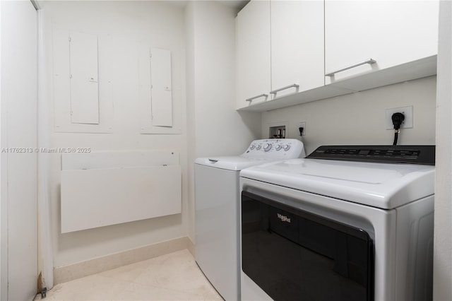 laundry area with electric panel, cabinet space, light tile patterned floors, and washer and clothes dryer