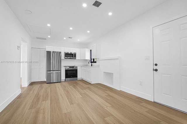 kitchen featuring visible vents, white cabinetry, recessed lighting, light wood-style floors, and appliances with stainless steel finishes