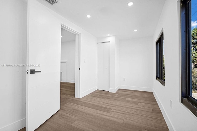 spare room with visible vents, recessed lighting, wood finished floors, and baseboards