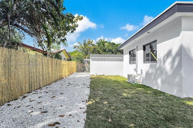 view of yard with central AC unit and a fenced backyard