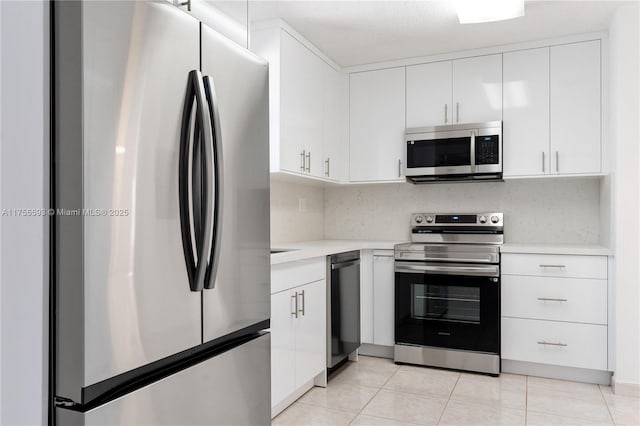 232 NW 58th Ct, Miami, FL 33126 - kitchen featuring light tile patterned floors, stainless steel appliances, white cabinets, and light countertops