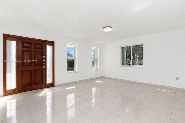 232 NW 58th Ct, Miami, FL 33126 - foyer entrance with light tile patterned flooring