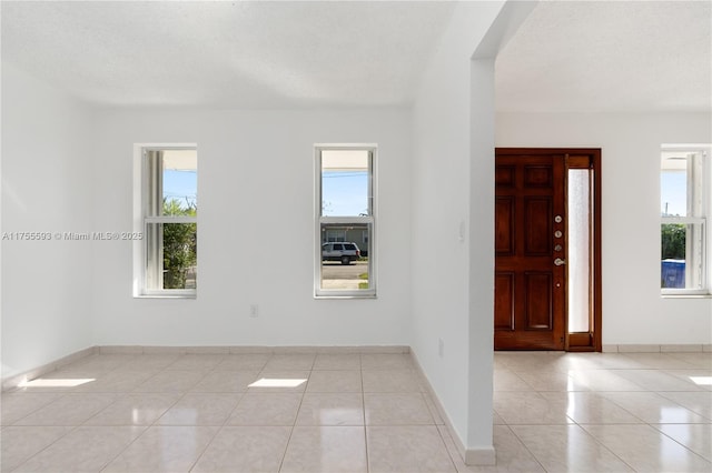 232 NW 58th Ct, Miami, FL 33126 - entrance foyer with a wealth of natural light, baseboards, and light tile patterned floors