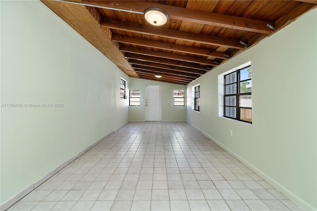 232 NW 58th Ct, Miami, FL 33126 - spare room with light tile patterned floors, baseboards, lofted ceiling with beams, and wooden ceiling