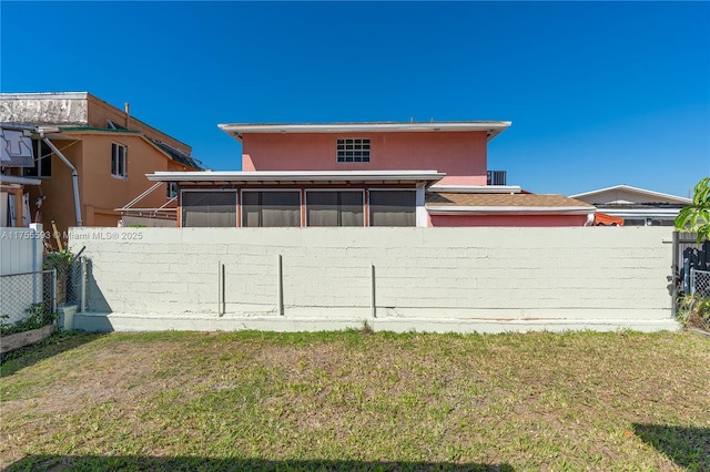 232 NW 58th Ct, Miami, FL 33126 - rear view of property featuring fence, a lawn, and a sunroom