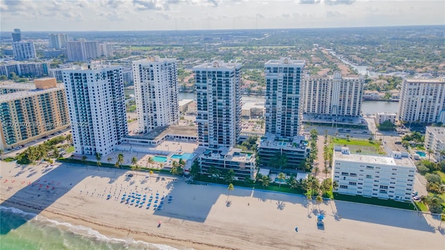 aerial view featuring a city view, a view of the beach, and a water view