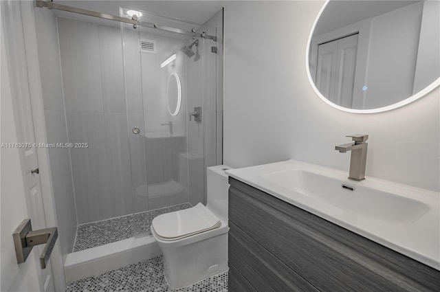 full bathroom with vanity, a shower stall, toilet, and visible vents