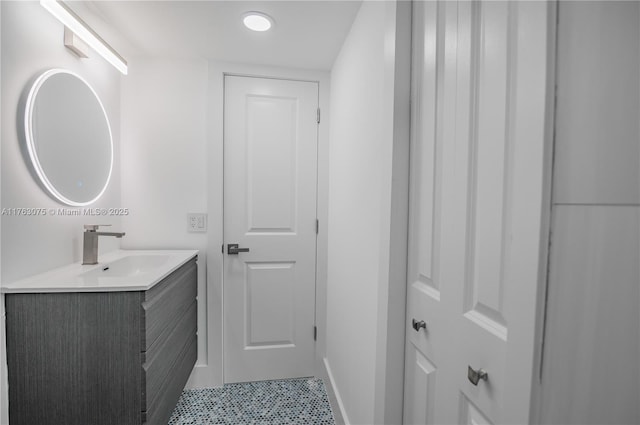 bathroom featuring baseboards and vanity