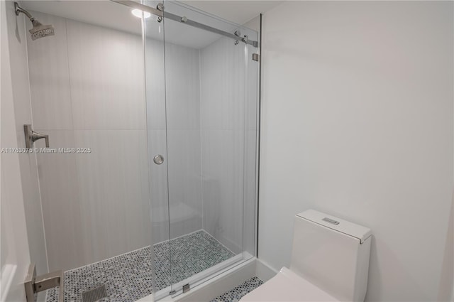 full bath with a shower stall and toilet