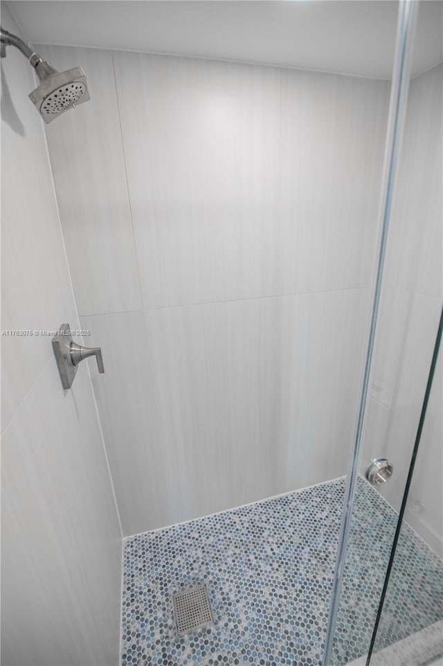 bathroom with tiled shower