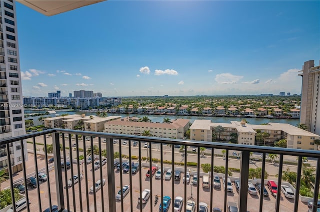 balcony featuring a water view and a city view