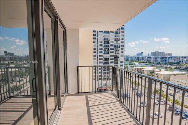 balcony with a view of city and a water view