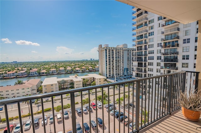 balcony with a water view and a view of city