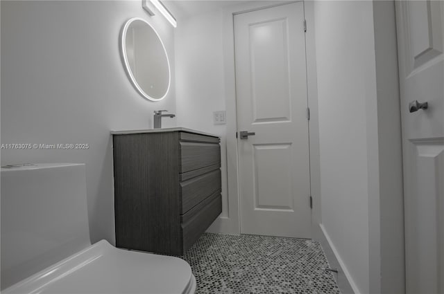 bathroom with baseboards and vanity