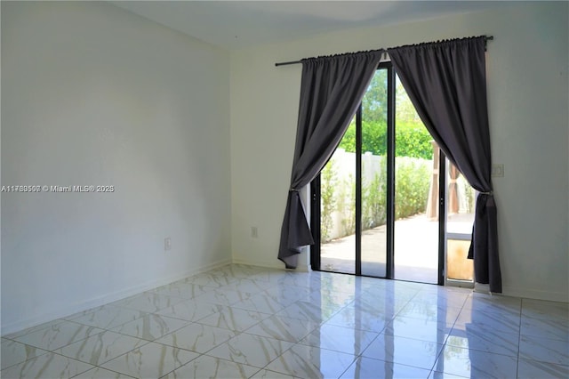 empty room with baseboards and marble finish floor