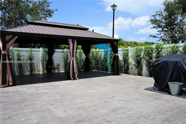 view of patio with grilling area and a fenced backyard