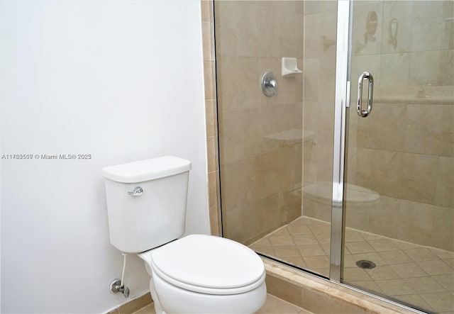 bathroom featuring a shower stall and toilet