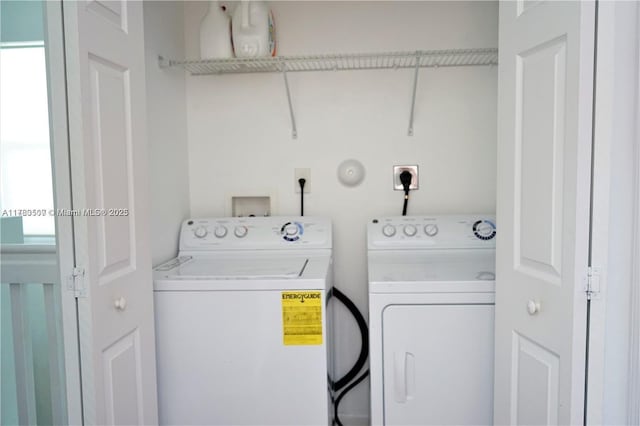 laundry room featuring washing machine and clothes dryer and laundry area